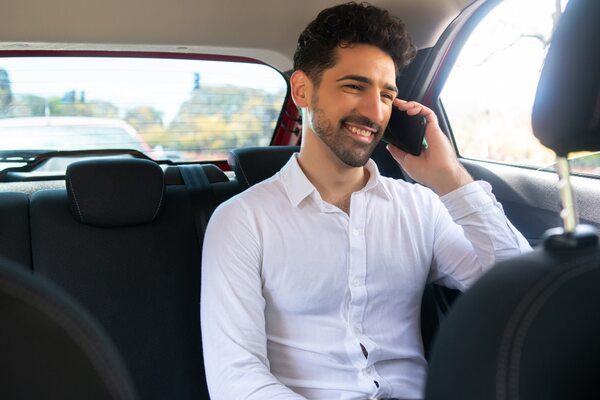 portrait-businessman-talking-phone-way-work-car (1) (1)